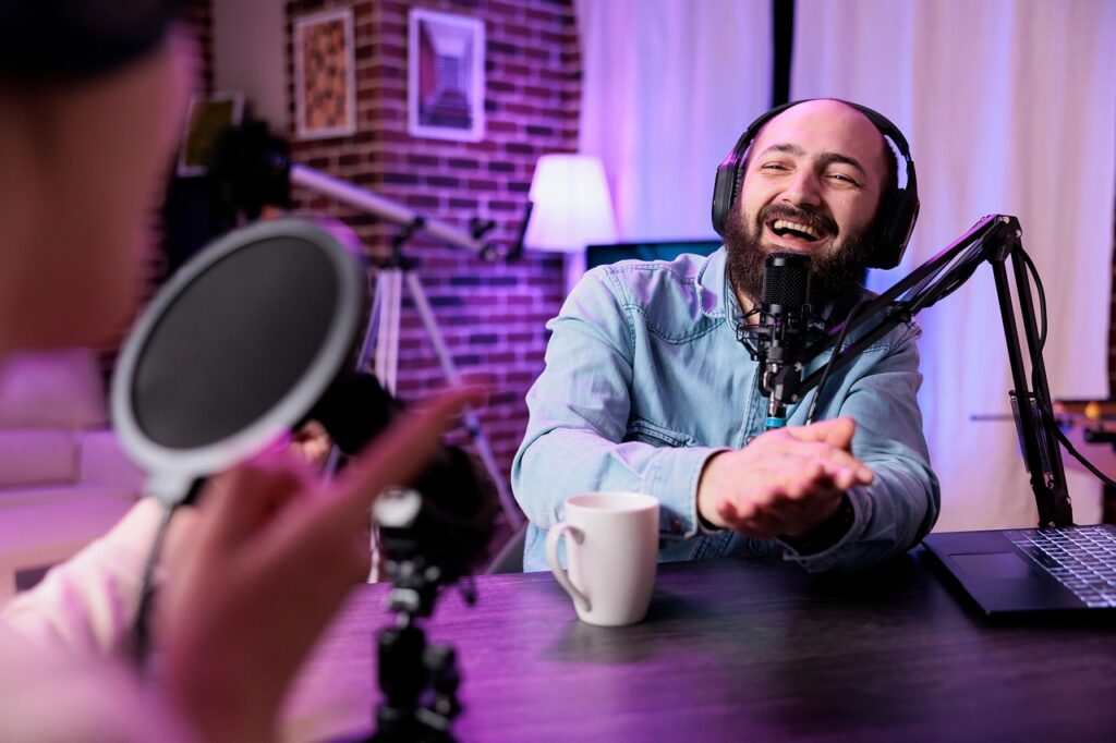 Bearded influencer recording a podcast about sponsorship trends and digital content strategies in a cozy studio setup.