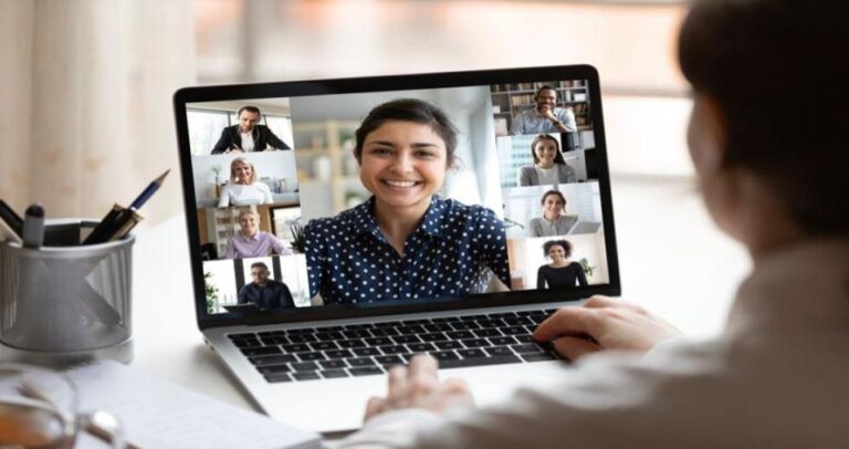 A student working on a laptop at home during their first internship, participating in a virtual onboarding session.