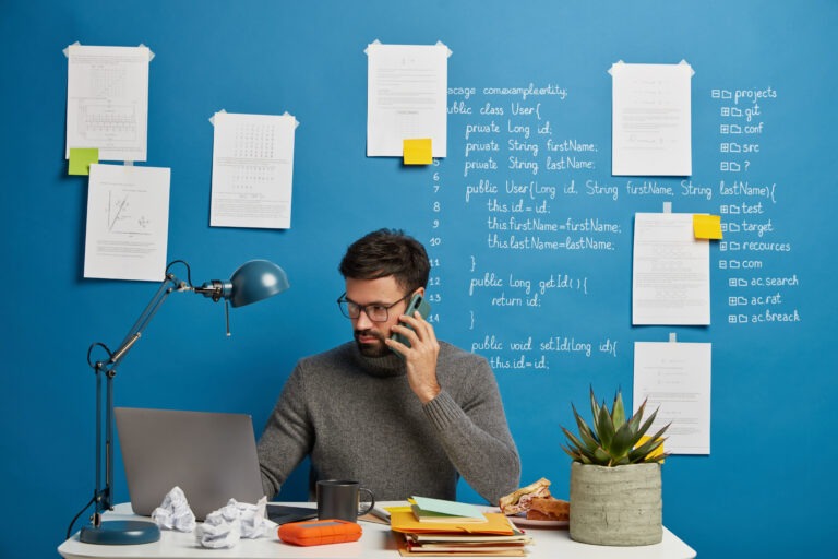 An employee on a phone call managing some task professionally